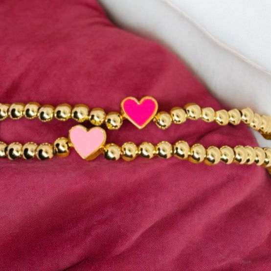 Gold beaded bracelet with colored heart